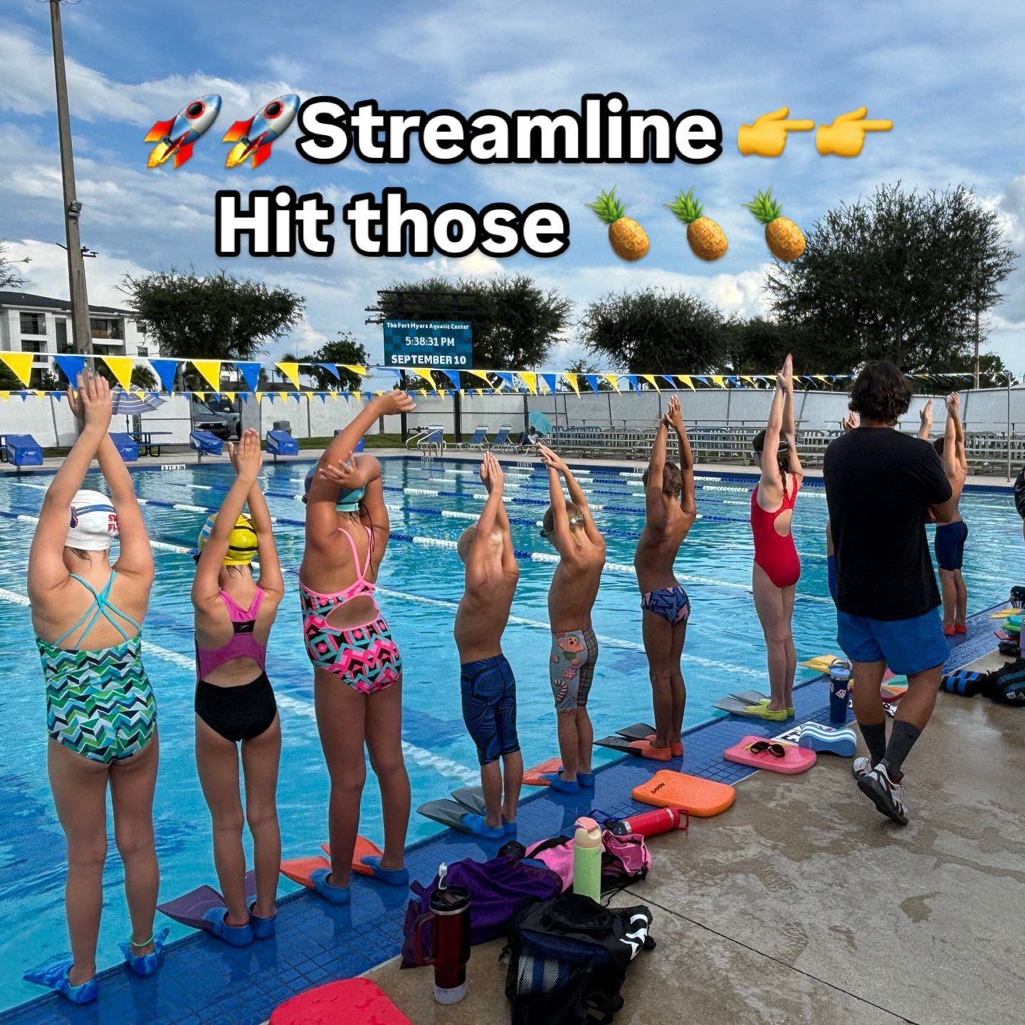Children at poolside practicing swimming techniques, guided by an instructor with motivational text and emojis above.